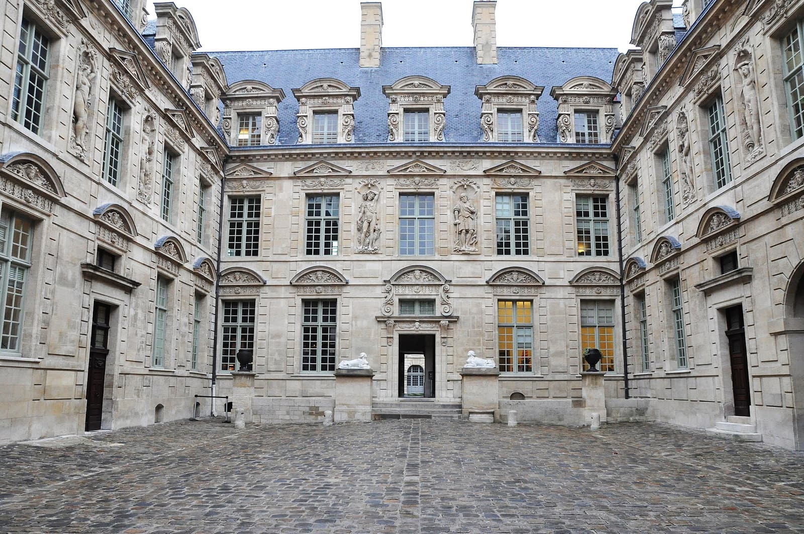 The inner courtyard of the Hôtel de Sully with its sculpted stone facade and high slate roof