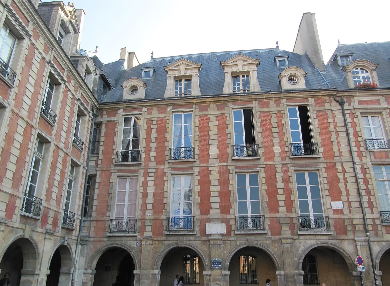 The red-brick facade and arcades of the Hôtel de Rohan-Guéménée, home of the Maison de Victor Hugo
