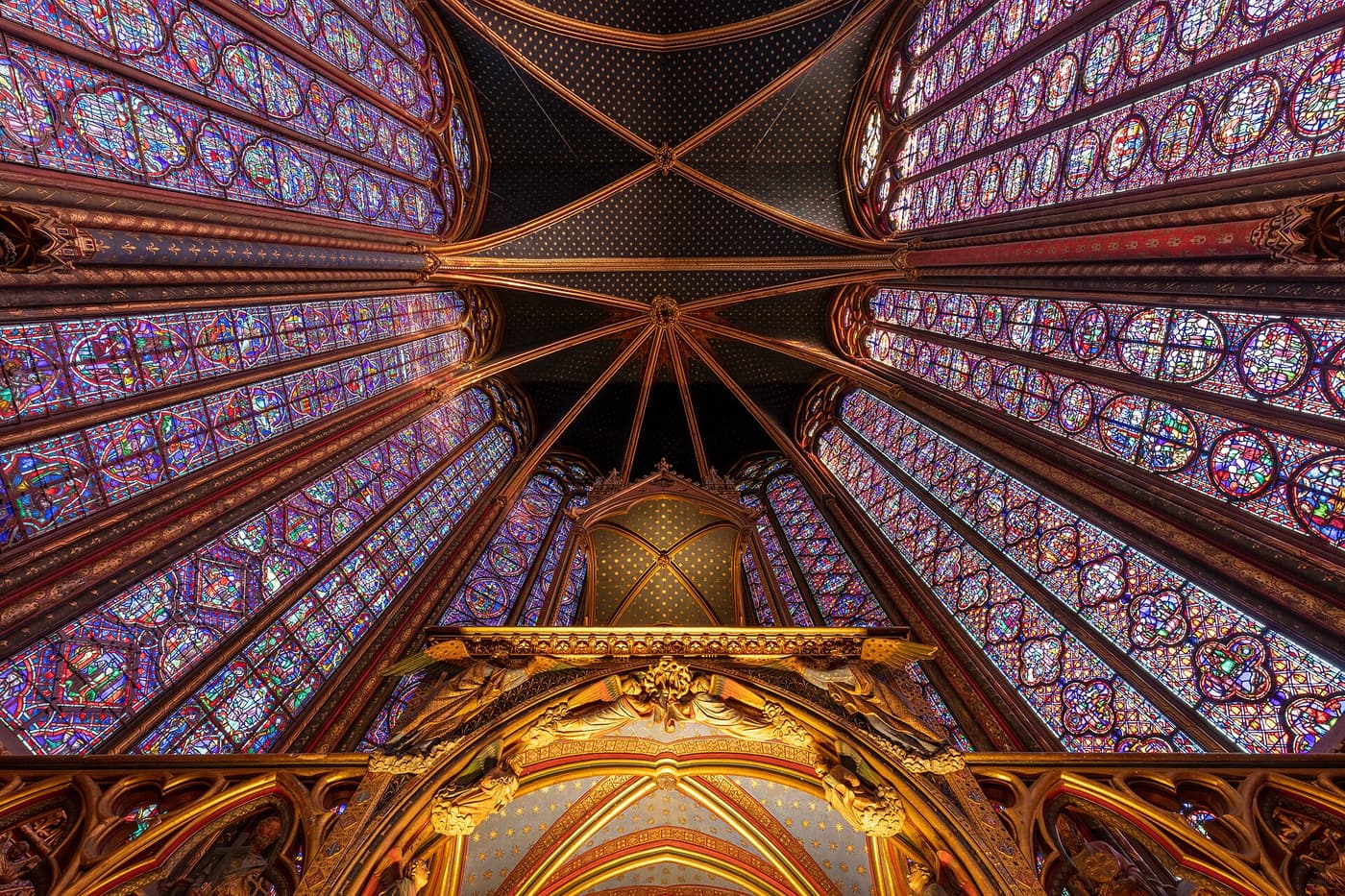 The upper chapel of Sainte-Chapelle, walled with tall medieval stained-glass windows